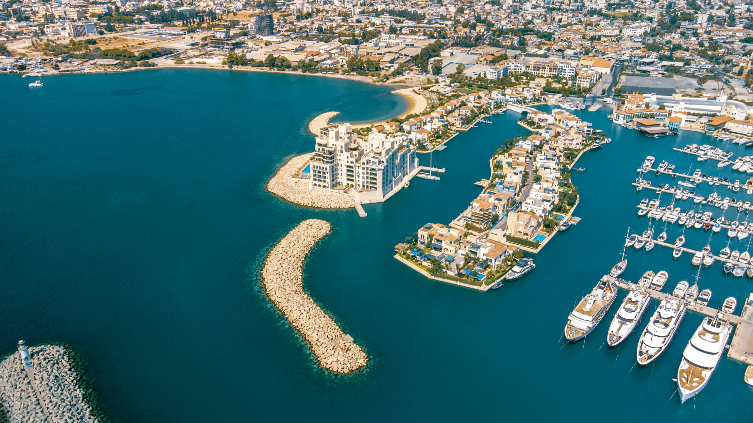 Aerial drone view of Limassol Marina with residential buildings and yachts